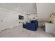 Comfortable living space featuring a blue sectional sofa, TV, and a desk area at 90 Mckown Rd, Fayetteville, GA 30214