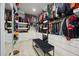 Spacious walk-in closet features custom shelving, ample hanging space, and a stylish black upholstered bench at 90 Mckown Rd, Fayetteville, GA 30214