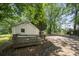 Exterior view of home's backyard with deck and spacious driveway at 1472 Norman Berry Dr, Atlanta, GA 30344