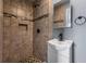 Renovated bathroom featuring tile shower, mosaic accents, and pedestal sink at 1472 Norman Berry Dr, Atlanta, GA 30344