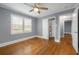Bedroom featuring hardwood floors, ceiling fan, and access to full bathroom at 1472 Norman Berry Dr, Atlanta, GA 30344