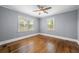 Bedroom featuring hardwood floors, fresh paint, and two windows at 1472 Norman Berry Dr, Atlanta, GA 30344