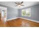 Bedroom featuring hardwood floors, ceiling fan, and windows for natural light at 1472 Norman Berry Dr, Atlanta, GA 30344