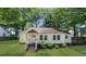 Quaint single-story home featuring a well-manicured lawn and mature trees at 1472 Norman Berry Dr, Atlanta, GA 30344