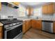View of the spacious kitchen featuring stainless steel appliances and light wood cabinetry at 1472 Norman Berry Dr, Atlanta, GA 30344