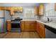 Updated kitchen with stainless steel appliances, light-wood cabinets, and lots of countertop space at 1472 Norman Berry Dr, Atlanta, GA 30344