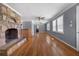 Spacious living room boasts hardwood floors, a stone fireplace, and ample natural light at 1472 Norman Berry Dr, Atlanta, GA 30344