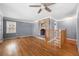Living room with hardwood floors, stone fireplace, and ceiling fans for maximum comfort at 1472 Norman Berry Dr, Atlanta, GA 30344