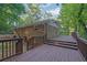 Home's backyard featuring a large wooden deck and a wooded view at 2286 Capehart Ne Cir, Atlanta, GA 30345