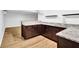 Basement bar featuring granite counters, dark cabinets, and wood-style flooring at 2286 Capehart Ne Cir, Atlanta, GA 30345