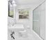 Bathroom with a classic pedestal sink, a walk-in shower, and a window for natural light at 2286 Capehart Ne Cir, Atlanta, GA 30345