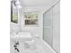 Bright bathroom featuring a toilet, sink, and a fully tiled shower/tub, offering a clean, modern aesthetic at 2286 Capehart Ne Cir, Atlanta, GA 30345