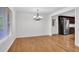 Dining area featuring hardwood floors, chandelier, and doorway to updated kitchen at 2286 Capehart Ne Cir, Atlanta, GA 30345