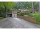 Exterior of home with brick facade, long driveway, brick planters, and wooded surroundings at 2286 Capehart Ne Cir, Atlanta, GA 30345