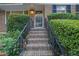 Inviting front entrance with brick steps and wrought iron railings framed by lush greenery at 2286 Capehart Ne Cir, Atlanta, GA 30345