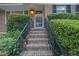 Brick steps with iron railings lead to the front door, framed by manicured greenery, adding to the home's appeal at 2286 Capehart Ne Cir, Atlanta, GA 30345