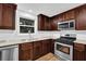 Renovated kitchen with stainless steel appliances, white subway tile backsplash, and window over sink at 2286 Capehart Ne Cir, Atlanta, GA 30345