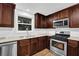 Updated kitchen features modern appliances, bright white backsplash, and dark wood cabinetry for a sleek design at 2286 Capehart Ne Cir, Atlanta, GA 30345