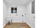 Neutral laundry room with utility sink and hardwood floors at 2286 Capehart Ne Cir, Atlanta, GA 30345
