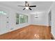 Bright living room featuring beautiful hardwood floors, a large window and a classic ceiling fan and light at 2286 Capehart Ne Cir, Atlanta, GA 30345
