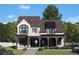 Charming two-story home with beautiful white brick, a covered porch, and lush landscaping at 245 Heatherton Way, Milton, GA 30009