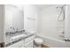 Bright bathroom features a granite countertop, white cabinets, and a shower and tub combination at 4457 Watson Ridge Dr, Stone Mountain, GA 30083