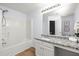 Clean bathroom with shower and tub combo, granite countertop and modern lighting at 4457 Watson Ridge Dr, Stone Mountain, GA 30083