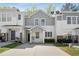 Charming two-story townhouse with grey and white exterior, a well-maintained lawn, and private driveway at 4457 Watson Ridge Dr, Stone Mountain, GA 30083
