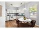 Bright kitchen with white cabinets, granite countertops, modern appliances, and a cozy dining area at 4457 Watson Ridge Dr, Stone Mountain, GA 30083