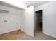 Bright laundry room with storage space, white walls, laminate wood floors, and carpet in the hallway at 4457 Watson Ridge Dr, Stone Mountain, GA 30083