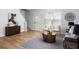 Open-concept living area with hardwood floors, stylish furniture, and a decorative rug at 4457 Watson Ridge Dr, Stone Mountain, GA 30083