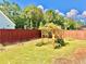 Lush backyard with wooden pergola and well-manicured lawn at 5599 Wheeler Ridge Rd, Auburn, GA 30011
