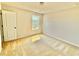 Bedroom with neutral walls and carpet features a window with a view at 5599 Wheeler Ridge Rd, Auburn, GA 30011