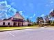 A modern community clubhouse includes a parking area and well-manicured landscaping at 5599 Wheeler Ridge Rd, Auburn, GA 30011