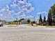 Stone monument marking the entrance to the community, under a blue, partly cloudy sky at 5599 Wheeler Ridge Rd, Auburn, GA 30011