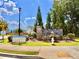 A stone community sign is decorated with seasonal banners and beautiful landscaping at 5599 Wheeler Ridge Rd, Auburn, GA 30011