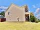 Side view of the house with a well-manicured lawn and landscaping at 5599 Wheeler Ridge Rd, Auburn, GA 30011