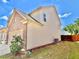Side exterior elevation with brick accents, landscaped yard, and two-car garage at 5599 Wheeler Ridge Rd, Auburn, GA 30011