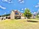 Exterior shot of the property showing lawn, landscaping, and neighborhood street at 5599 Wheeler Ridge Rd, Auburn, GA 30011