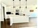 Modern kitchen featuring white cabinets, a center island with pendant lights, and stainless steel appliances at 5599 Wheeler Ridge Rd, Auburn, GA 30011