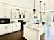 Modern kitchen featuring white cabinets, a center island with pendant lights, and stainless steel appliances at 5599 Wheeler Ridge Rd, Auburn, GA 30011