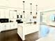 Modern kitchen featuring white cabinets, a center island with pendant lights, and stainless steel appliances at 5599 Wheeler Ridge Rd, Auburn, GA 30011