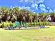 A modern community playground is surrounded by mature trees on a sunny day at 5599 Wheeler Ridge Rd, Auburn, GA 30011