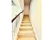 Classic staircase with carpeted steps and white railings, adding a touch of elegance to the home's design at 5599 Wheeler Ridge Rd, Auburn, GA 30011
