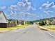 A quiet neighborhood street lined with sidewalks and mature trees at 5599 Wheeler Ridge Rd, Auburn, GA 30011