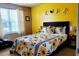 Bright bedroom with yellow walls, sunflower bedding and a decorative LOVE sign at 5626 Laurel Ridge Dr, Atlanta, GA 30344