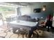 Garage transformed into a game room with an air hockey table, sofa and decorative rugs at 5626 Laurel Ridge Dr, Atlanta, GA 30344