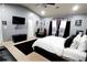 Stylish main bedroom with vaulted ceilings, TV, fan, a sitting area, and decorative artwork at 5626 Laurel Ridge Dr, Atlanta, GA 30344