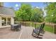 Charming deck with dining set and rocking chairs, perfect for outdoor gatherings at 730 Mount Oglethorpe Trl, Alpharetta, GA 30022