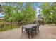 Beautiful back deck area with outdoor dining furniture and green views at 730 Mount Oglethorpe Trl, Alpharetta, GA 30022
